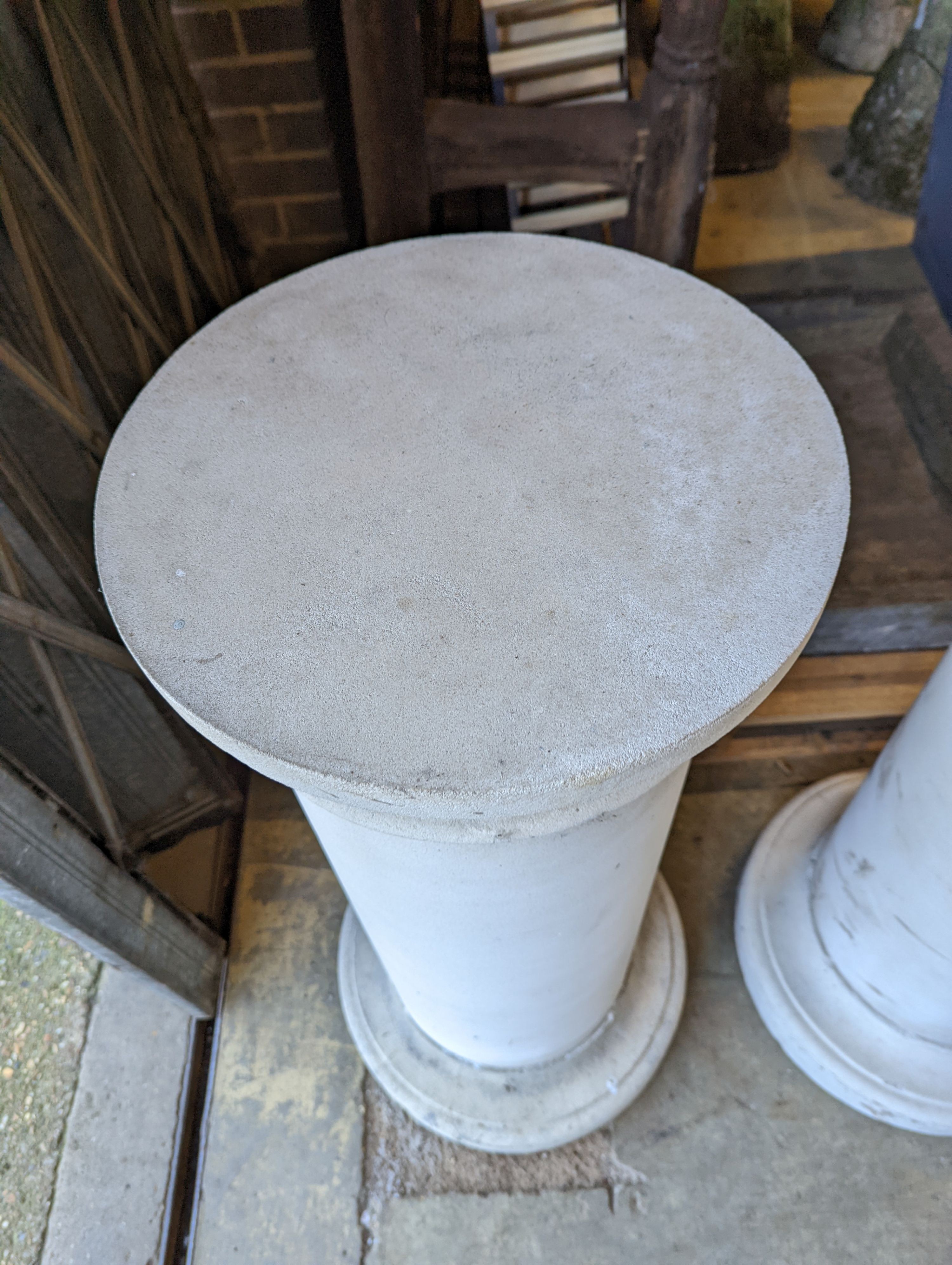 A pair of circular stone pedestals, tops 38cm diameter, height 99cm